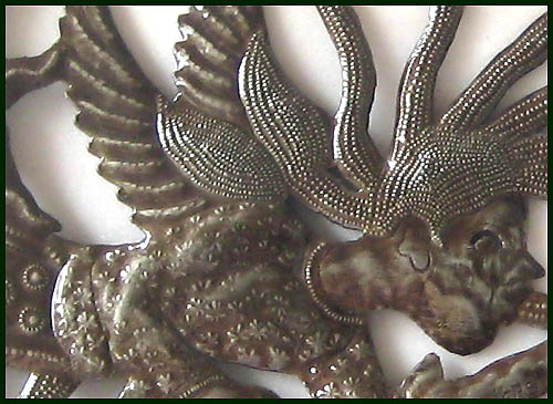 Close-up of angle design. Haitian metal art work.